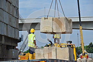 Construction workers stacking the maintain load test block at the construction site